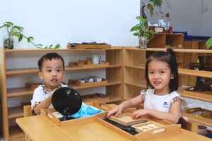 Two kids play at early childhood development programme - House of the Hill